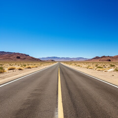 Fototapeta na wymiar long straight empty American highway in desert under blue sky: concept of freedom
