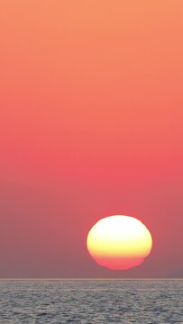 the sun is sinking into the sea. possible to accelerate the image stream. Vertical video for social media.	
