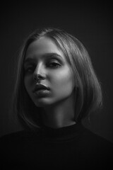 Dramatic black and white portrait of young blonde girl