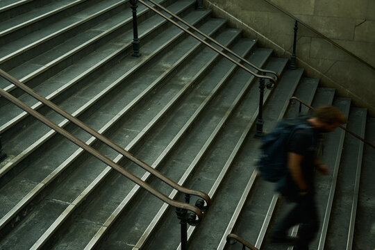 man walking in Paris metro tunnel stairs 