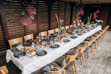 festive dinner outside the city on the terrace of the house, a beautifully served table with food