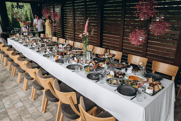 festive dinner outside the city on the terrace of the house, a beautifully served table with food
