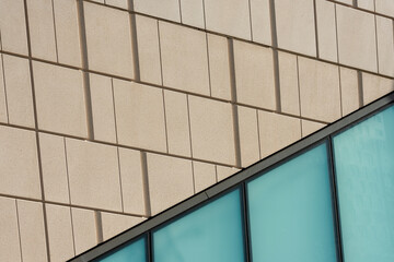 glass and sandstone modern building, close up exterior architecture.