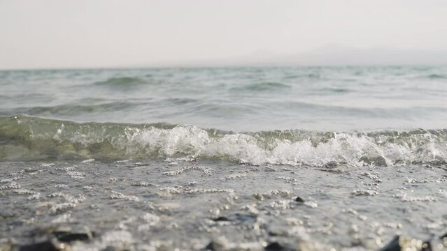 Slow motion closeup shot of clear water waves of a lake