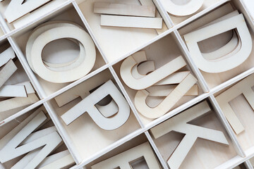wooden letters arranged alphabetically in a box