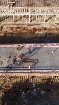 Vertical Video of Construction Workers in the Roof of New Building 