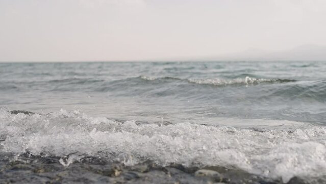 Slow motion closeup shot of clear water waves of a lake