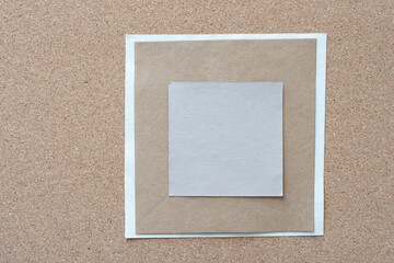 Fototapeta premium pile of paper cards mostly square in shape and arranged on cork