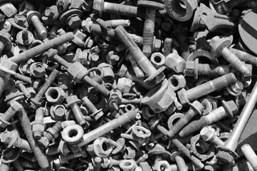 gray background, photo shows old rusty bolts, nuts and screws
