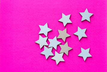 Fototapeta na wymiar wood stars on hot pink paper