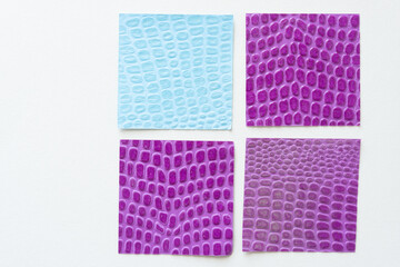 set of paper squares embossed with prints patterns on white paper