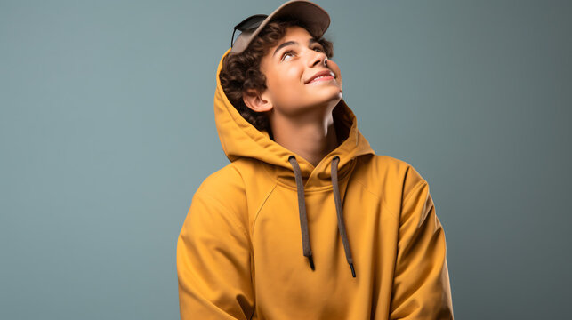 Teenager sport man with sport bag over isolated background and looking up