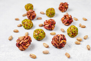 Superfood, raw healthy vegetarian snack, Medjool dates covered by chocolate, and various energy balls with nuts.