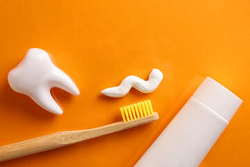 Toothpaste and toothbrush on a colored background. Dental care, oral health.