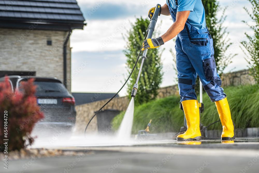 Wall mural powerful pressure washer using to clean dirty driveway