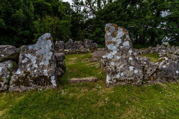 Din Lligwy ancient village in Anglesey, stone entrance to hut circle. - 654998185
