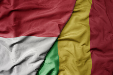big waving realistic national colorful flag of indonesia and national flag of mali .
