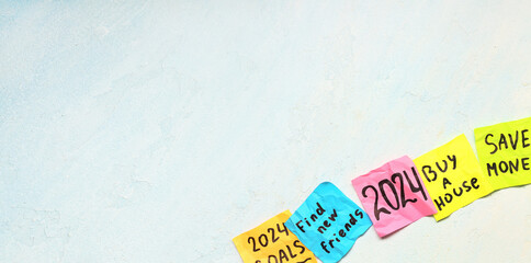 Note papers with written goals for new year 2024 on light background with space for text
