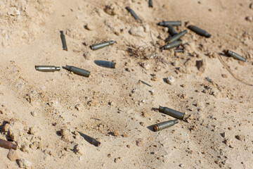 Bullet shells lie on the sand