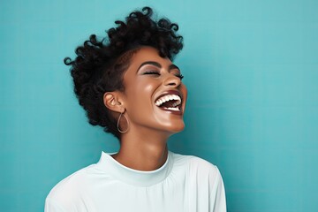 A joyful black woman with her mouth wide open in laughter, expressing pure happiness.