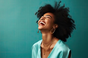 A joyful black woman with her mouth wide open in laughter, expressing pure happiness.