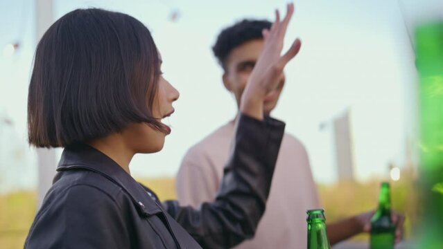 Dancing woman enjoying party at open air closeup. Diverse millennials having fun