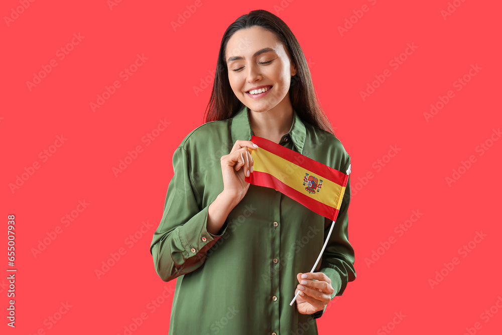 Sticker pretty young woman with flag of spain on red background