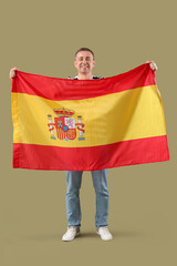 Mature man with flag of Spain on green background