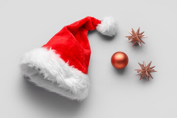 Obraz na płótnie Canvas Santa hat with Christmas toys on grey background