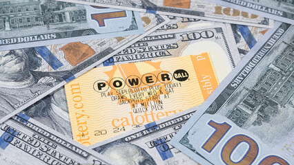 Lake Elsinore, CA, USA - September 30, 2023: Focus on Powerball lottery tickets surrounded by US...