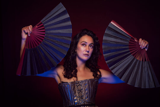 artistic studio portrait woman dancer holding hand fans