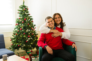Romantic couple hugging excited about celebrating christmas