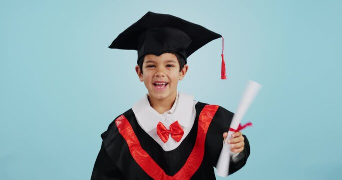 Graduate, child and celebration with portrait and happiness in studio on blue background for education. Development, kid and success with excited expression, diploma or certificate for achievement