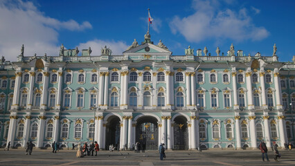 Fototapeta na wymiar Beautiful facade of old palace building. Action. Facade of ancient palace on sunny summer day. Beautiful architecture of old building of St. Petersburg Hermitage