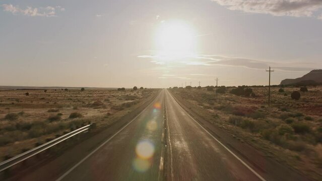 Driving down desert road, automobile point of view.