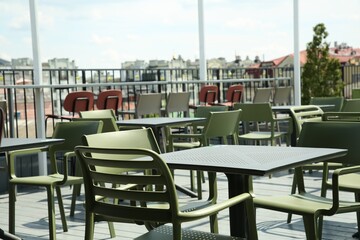 Observation area cafe. Tables and chairs on terrace against beautiful cityscape
