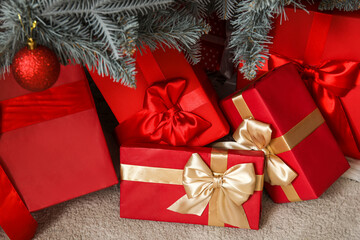 Gift boxes under Christmas tree in living room