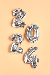 Figure 2024 made of balloons on orange background