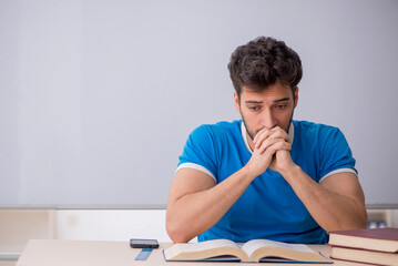 Young male student in front of whiteboard