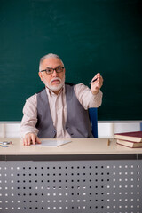 Old male teacher in the classroom