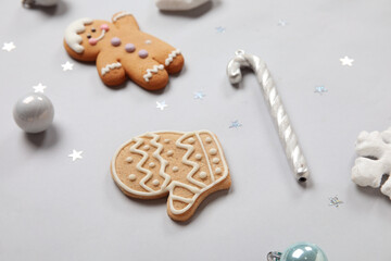 Christmas gingerbread cookies with decor on grey background