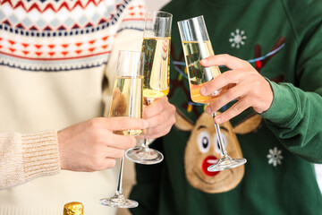 Young men with champagne celebrating Christmas in kitchen, closeup