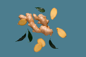 Flying fresh ginger root and leaves on blue background