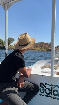 tourist in egypt watching a ruin temple in aswan on the nile