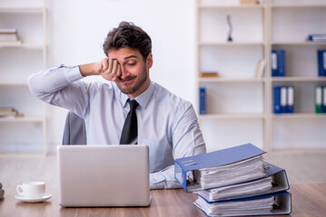 Young male employee working in the office