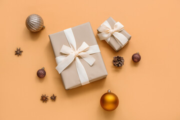 Fototapeta na wymiar Christmas balls and gift boxes on orange background
