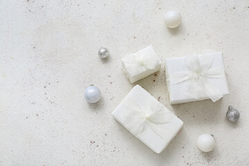 Fototapeta na wymiar Christmas balls and gift boxes on white background