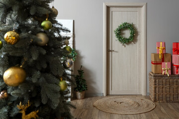 Christmas mistletoe wreath hanging on wooden door in room