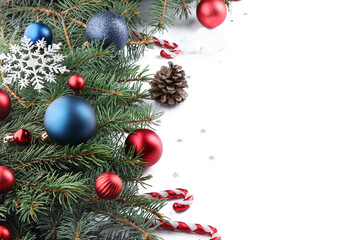Fir branches with Christmas balls, cones and decorations on white background