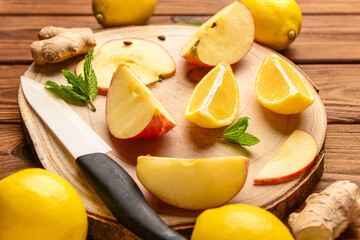 Board with ingredients for preparing lemonade on wooden background